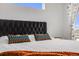 A bedroom with a padded headboard and a window above overlooking the neighborhood at 4390 Osage St, Denver, CO 80211