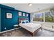Bright bedroom with a large window, modern furnishings, and stylish decor for a serene living space at 4390 Osage St, Denver, CO 80211