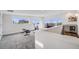 A large bonus room featuring multiple windows, a bar, a tv, and carpeted flooring at 4390 Osage St, Denver, CO 80211