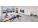 A large bonus room featuring multiple windows, a bar, a tv, and carpeted flooring at 4390 Osage St, Denver, CO 80211