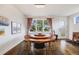 Bright dining room with unique round table, modern chandelier, and hardwood floors at 4390 Osage St, Denver, CO 80211