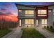 Modern townhome with gray and red exterior, clean landscaping, and inviting entryways at 4390 Osage St, Denver, CO 80211