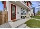 Inviting front entrance with a red door, decorative wood accents, and well-maintained landscaping at 4390 Osage St, Denver, CO 80211