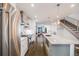 Spacious kitchen overlooking dining and living areas, stainless steel appliances, and hardwood floors at 4390 Osage St, Denver, CO 80211