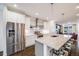 Modern kitchen with stainless steel appliances, white cabinets, and large island with seating at 4390 Osage St, Denver, CO 80211