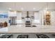 Well-lit kitchen with stainless appliances, granite counters, and open shelving at 4390 Osage St, Denver, CO 80211