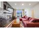 Cozy living room with tile fireplace, mantel, and a comfortable couch at 4390 Osage St, Denver, CO 80211