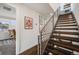 Staircase featuring wood stairs, a metal railing, and wall decor at 4390 Osage St, Denver, CO 80211