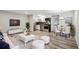 Open concept living area with modern finishes, stainless steel appliances, and eat-in dining space at 5875 E Iliff Ave # 108, Denver, CO 80222