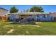 Back exterior featuring a spacious wooden deck, lawn area, and light blue siding with white trim at 4533 S Devinney St, Morrison, CO 80465