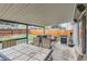 Covered patio with outdoor dining area and grill, leading to a fenced backyard at 4533 S Devinney St, Morrison, CO 80465