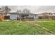 Backyard with solar panels and a patio with outdoor seating and green grass at 4533 S Devinney St, Morrison, CO 80465