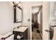 Bathroom with dark vanity and sink next to the toilet and open doorway into the bedroom at 4533 S Devinney St, Morrison, CO 80465