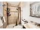 Bathroom features tiled shower with toiletry caddy and neutral wall and floor tile at 4533 S Devinney St, Morrison, CO 80465