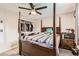 Bedroom with a four-poster bed, a ceiling fan, and a closet with ample storage space at 4533 S Devinney St, Morrison, CO 80465