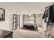 Bedroom with gray paneled accent wall, iron canopy bed, carpet, and decor shelving at 4533 S Devinney St, Morrison, CO 80465
