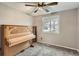 Bedroom featuring a large, ornate piano next to a window and carpeted floors at 4533 S Devinney St, Morrison, CO 80465