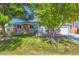 Charming brick-accented home with a well-manicured lawn and mature tree at 4533 S Devinney St, Morrison, CO 80465