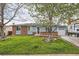Charming single-Gathering home with a well-maintained lawn and tree in the front yard at 4533 S Devinney St, Morrison, CO 80465