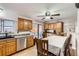 Eat-in kitchen with wood cabinets, stainless steel appliances, and sliding door access to the backyard at 4533 S Devinney St, Morrison, CO 80465