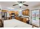 Bright eat-in kitchen featuring wood cabinets, stainless steel appliances, and backyard access at 4533 S Devinney St, Morrison, CO 80465