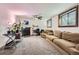 Spacious living room offers a cozy fireplace, plush seating, a ceiling fan, and rustic window trim for a warm, inviting atmosphere at 4533 S Devinney St, Morrison, CO 80465