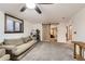 Living room with sliding barn door into bedroom and a large gray couch at 4533 S Devinney St, Morrison, CO 80465