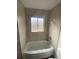 Cozy bathroom featuring a tub, shower, and tiled walls at 2017 Ironton St, Aurora, CO 80010