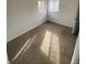 Simple bedroom featuring wall-to-wall carpet and two windows at 2017 Ironton St, Aurora, CO 80010