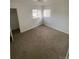 Bright bedroom featuring wall-to-wall carpet and two windows at 2017 Ironton St, Aurora, CO 80010