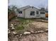 Simple single-story home with a small front yard featuring rocks and some grass at 2017 Ironton St, Aurora, CO 80010