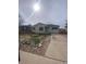 Modest single-story home with a large front yard and mature trees at 2017 Ironton St, Aurora, CO 80010