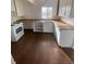 The kitchen has new laminate flooring, a stove, sink, and open shelving at 2017 Ironton St, Aurora, CO 80010