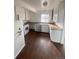 Functional kitchen with white cabinets, wood countertops, and updated appliances at 2017 Ironton St, Aurora, CO 80010