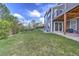 Large grassy backyard with patio, deck, mature trees, and playful swing set at 9786 Malachite Ct, Parker, CO 80134