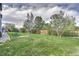 Green, expansive backyard, framed by trees and a wooden fence for privacy at 9786 Malachite Ct, Parker, CO 80134