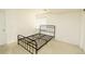 Clean bedroom featuring carpeted floors, a metal frame bed, and a window at 9786 Malachite Ct, Parker, CO 80134