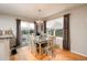 Dining area features a modern light fixture and sliding glass doors to the deck at 9786 Malachite Ct, Parker, CO 80134