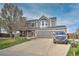 Two-story home with a gray exterior, attached garage, brick accents and a well-manicured front yard at 9786 Malachite Ct, Parker, CO 80134