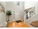 Grand foyer with tall ceilings, hardwood floors, modern staircase, and a front door with sidelights at 9786 Malachite Ct, Parker, CO 80134