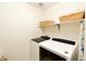 Convenient laundry room with modern washer and dryer, plus overhead shelving for storage at 9786 Malachite Ct, Parker, CO 80134