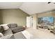Comfortable living room with vaulted ceilings, large sectional couch, and a mounted television at 9786 Malachite Ct, Parker, CO 80134