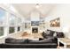 Cozy living room featuring a fireplace, built-in shelving, large windows, and comfortable sofas at 9786 Malachite Ct, Parker, CO 80134