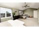 Spacious bedroom with large windows, ceiling fan, and a sitting area with a comfortable couch at 9786 Malachite Ct, Parker, CO 80134