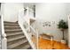 Open staircase with carpeted steps, white railing, and hardwood floors leading to the upper level at 9786 Malachite Ct, Parker, CO 80134