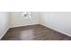 Well-lit bedroom featuring wood-look flooring and a window offering natural light at 1401 Bloom St, Brighton, CO 80601