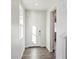 Bright foyer with wood-look flooring, a large window and a white front door at 1401 Bloom St, Brighton, CO 80601