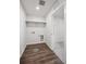 Functional laundry room with wood-look floors and white walls, ready for appliances and storage at 1401 Bloom St, Brighton, CO 80601