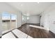 Bright living room featuring hardwood floors, recessed lights, and sliding glass door at 1401 Bloom St, Brighton, CO 80601