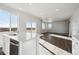 Open-concept living area with lots of sunlight, recessed lights, and hardwood floors at 1401 Bloom St, Brighton, CO 80601